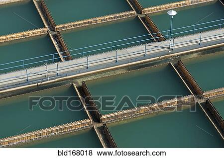 Aerial view of walkway over water treatment tanks View Large Photo Image Stock Photo - Aerial view of walkway over water treatment tanks. Fotosearch