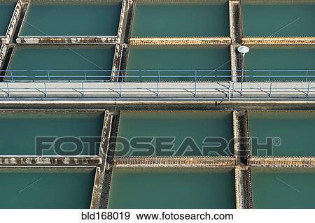 Stock Photo - Aerial view of walkway over water treatment tanks. Fotosearch