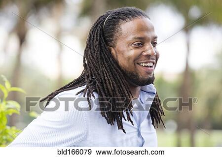 Stock Photo - African American businessman standing outdoors. Fotosearch