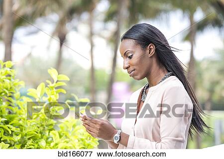 African American businesswoman using cell phone outdoors View Large Photo Image Stock Photo - African American businesswoman using cell phone outdoors. Fotosearch