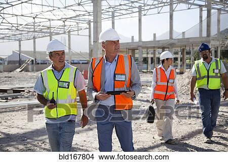 Picture - Architects talking at construction site. Fotosearch