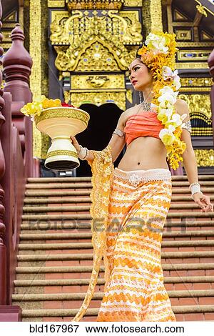 Stock Photo - Asian woman at ornate Buddhist temple, Chiang Mai, Chiang Mai, Thailand. Fotosearch