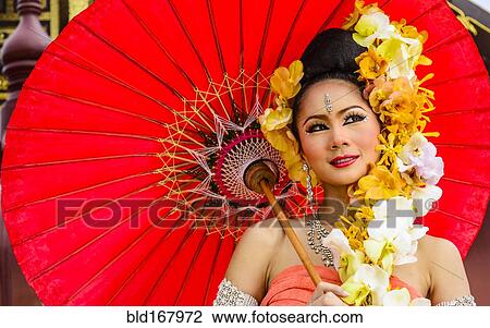 Asian woman with flower headdress holding parasol View Large Photo Image Stock Image - Asian woman with flower headdress holding parasol. Fotosearch
