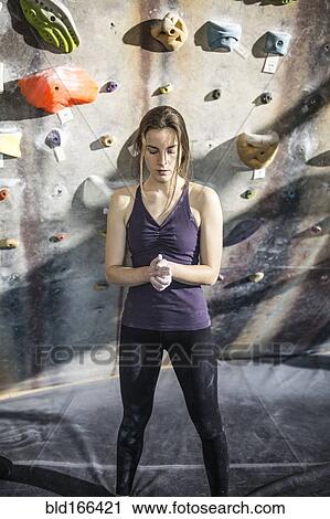 Athlete chalking her hands at rock wall in gym View Large Photo Image Stock Image - Athlete chalking her hands at rock wall in gym. Fotosearch