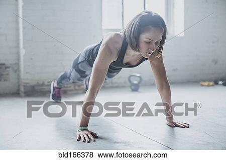 Athlete doing push-ups in gym View Large Photo Image Stock Photo - Athlete doing push-ups in gym. Fotosearch