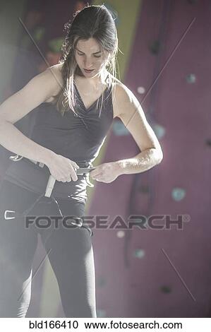 Athlete fastening climbing harness in gym View Large Photo Image Stock Image - Athlete fastening climbing harness in gym. Fotosearch