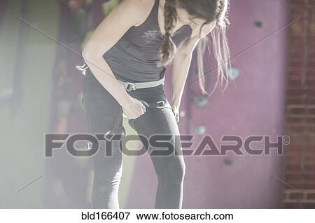 Athlete fastening climbing harness in gym View Large Photo Image Stock Photo - Athlete fastening climbing harness in gym. Fotosearch