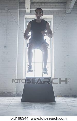 Picture - Athlete jumping on platform. Fotosearch