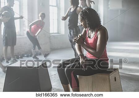 Stock Photography - Athlete listening to mp3 player in gym. Fotosearch