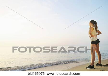 Athlete overlooking ocean on beach View Large Photo Image Stock Photography - Athlete overlooking ocean on beach. Fotosearch