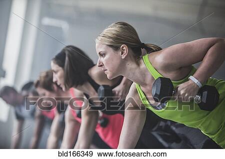 Athletes doing push-ups and lifting weights View Large Photo Image Stock Photo - Athletes doing push-ups and lifting weights. Fotosearch