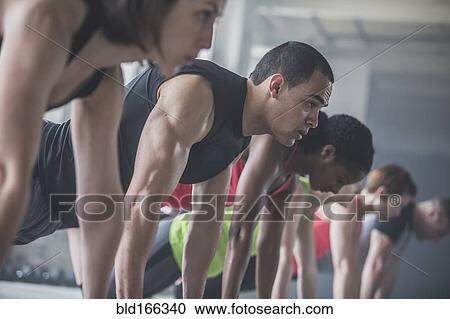 Stock Image - Athletes doing push-ups. Fotosearch