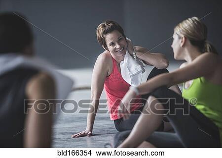 Athletes resting on floor View Large Photo Image Picture - Athletes resting on floor. Fotosearch