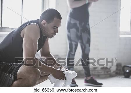 Stock Photograph - Athletes resting with towel. Fotosearch