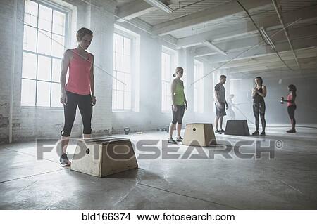 Picture - Athletes standing at platforms in gym. Fotosearch
