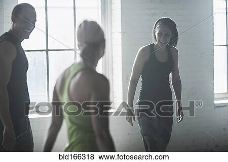 Stock Photo - Athletes talking in gym. Fotosearch