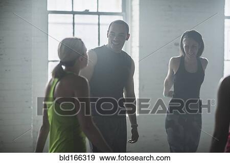Stock Photo - Athletes talking in gym. Fotosearch