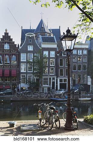 Stock Image - Bicycles parked at Amsterdam canal, Netherland. Fotosearch