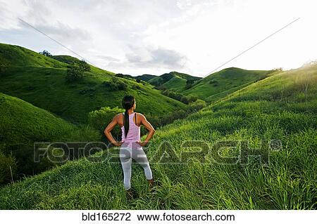 Black athlete admiring scenic view from rural hillside View Large Photo Image Stock Image - Black athlete admiring scenic view from rural hillside. Fotosearch