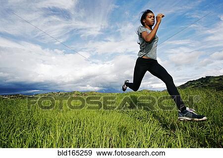 Black athlete running in rural field View Large Photo Image Stock Photo - Black athlete running in rural field. Fotosearch
