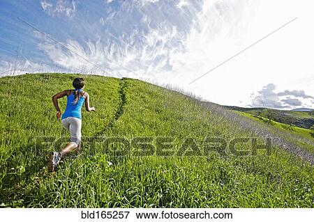 Black athlete running on rural hillside View Large Photo Image Stock Photo - Black athlete running on rural hillside. Fotosearch