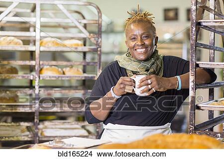 Black baker drinking coffee in bakery kitchen View Large Photo Image Picture - Black baker drinking coffee in bakery kitchen. Fotosearch