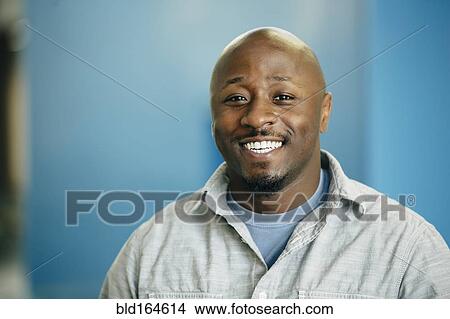Picture - Black businessman smiling in office. Fotosearch