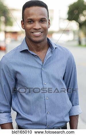 Black businessman smiling outdoors View Large Photo Image Stock Image - Black businessman smiling outdoors. Fotosearch