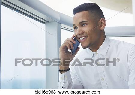 Stock Photo - Black businessman talking on cell phone. Fotosearch