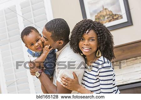 Stock Photo - Black family playing in living room. Fotosearch