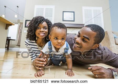 Black family playing on living room floor View Large Photo Image Stock Image - Black family playing on living room floor. Fotosearch