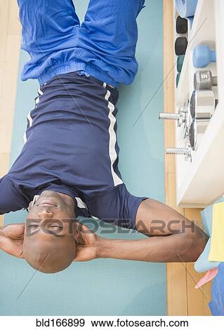 Black man doing sit-ups in gym View Large Photo Image Stock Photo - Black man doing sit-ups in gym. Fotosearch