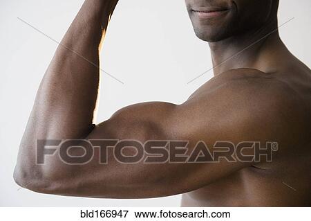 Stock Photo - Black man flexing muscles. Fotosearch