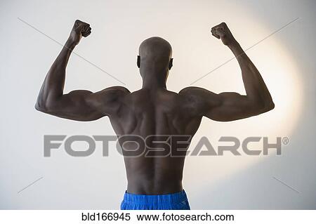 Black man flexing muscles View Large Photo Image Stock Photography - Black man flexing muscles. Fotosearch