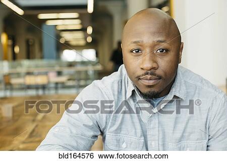 Stock Photograph - Black man sitting in cafe. Fotosearch