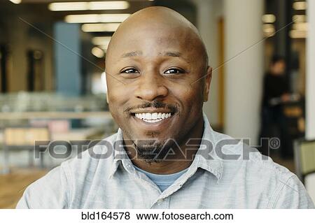 Black man smiling in cafe View Large Photo Image Stock Photo - Black man smiling in cafe. Fotosearch