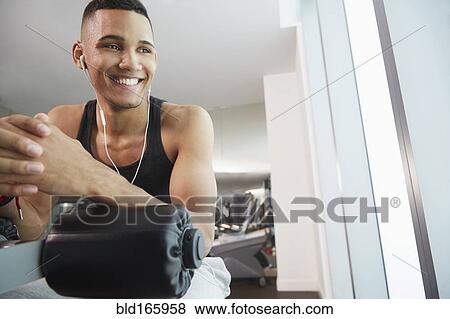 Black man smiling on exercise machine in gym View Large Photo Image Stock Photo - Black man smiling on exercise machine in gym. Fotosearch