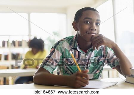 Stock Photo - Black student thinking in classroom. Fotosearch