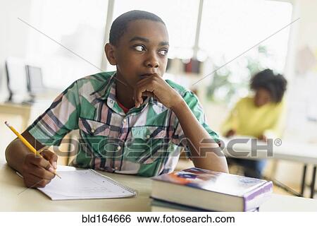 Stock Photograph - Black student thinking in classroom. Fotosearch