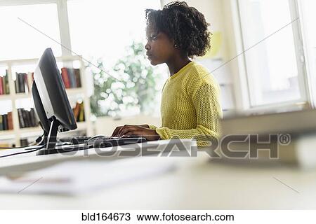 Black student using computer in classroom View Large Photo Image Stock Image - Black student using computer in classroom. Fotosearch