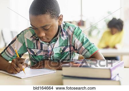 Black student writing in classroom View Large Photo Image Picture - Black student writing in classroom. Fotosearch