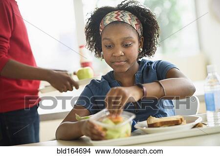 Picture - Black students eating lunch in school cafeteria. Fotosearch