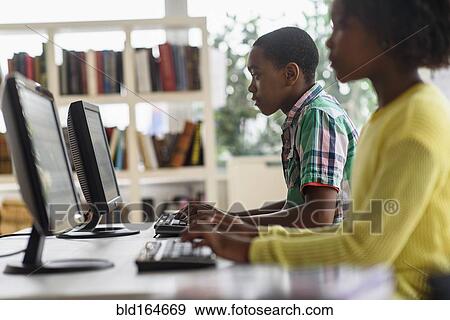 Stock Photo - Black students using computers in classroom. Fotosearch