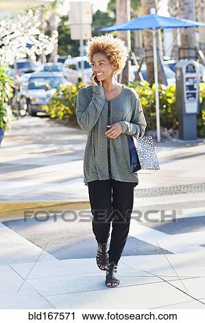 Black woman crossing city street View Large Photo Image Stock Image - Black woman crossing city street. Fotosearch