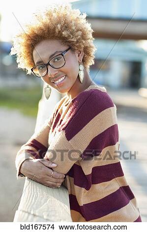 Black woman leaning on fence outdoors View Large Photo Image Picture - Black woman leaning on fence outdoors. Fotosearch