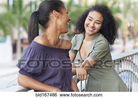Black woman talking on balcony outdoors View Large Photo Image Stock Photograph - Black woman talking on balcony outdoors. Fotosearch