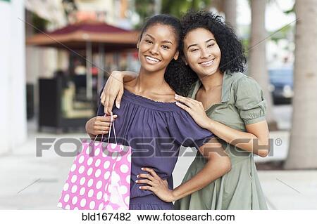 Black women smiling on city sidewalk View Large Photo Image Stock Image - Black women smiling on city sidewalk. Fotosearch