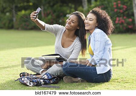 Black women taking selfie in park View Large Photo Image Stock Photo - Black women taking selfie in park. Fotosearch