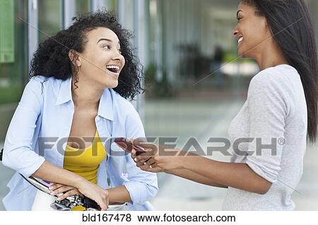 Black women talking on sidewalk View Large Photo Image Stock Photo - Black women talking on sidewalk. Fotosearch