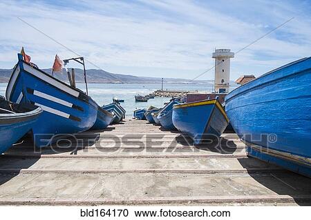 Blue boats docked on boat ramp View Large Photo Image Stock Image - Blue boats docked on boat ramp. Fotosearch